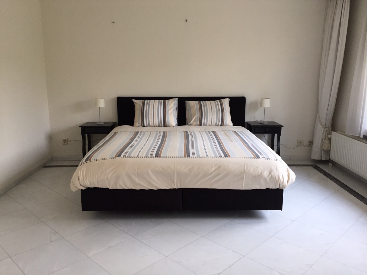 Beeld van tweepersoons bed in slaapkamer